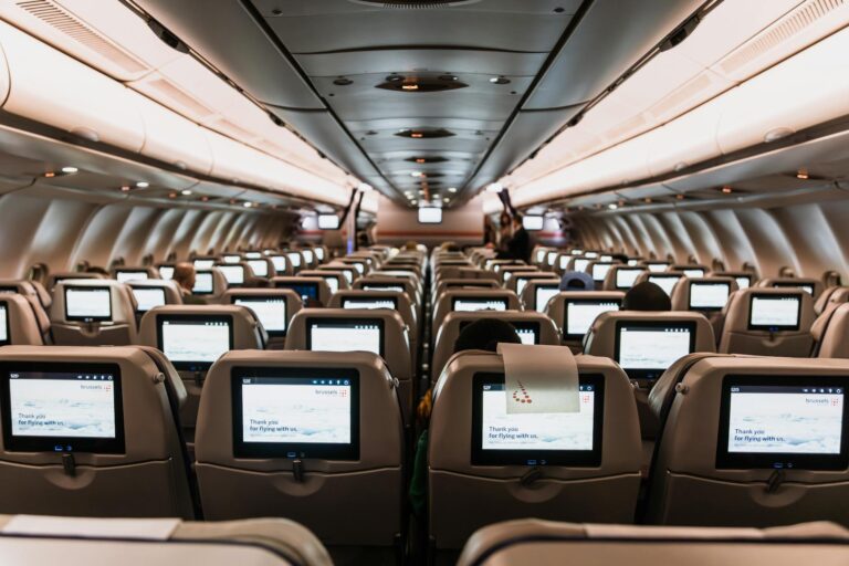 cabina de avión con pantallas de entretenimiento en todos los asientos