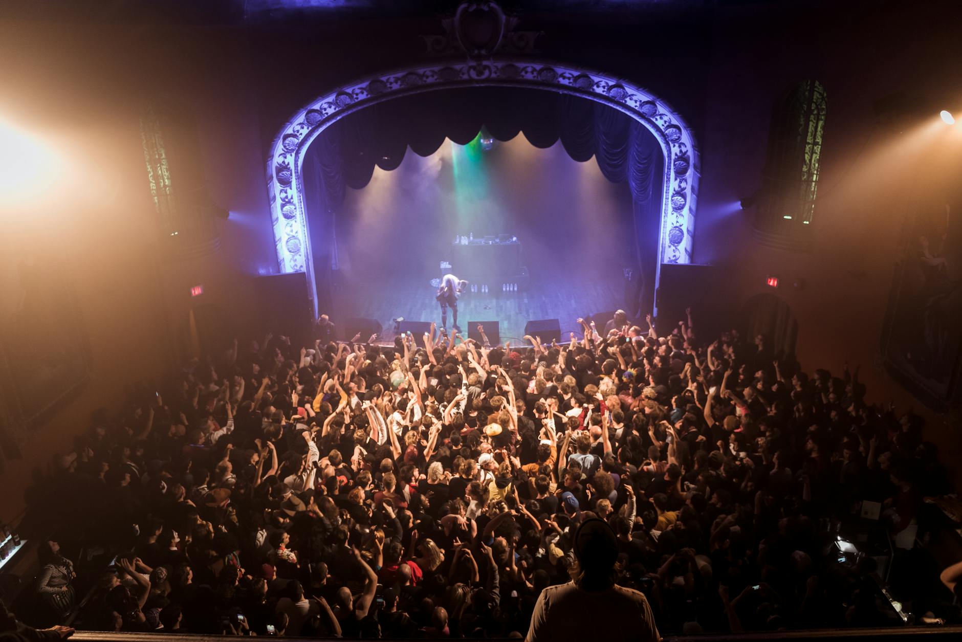 sala de conciertos con iluminación azul y gran aforo para espectáculos en vivo
