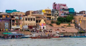 Barcas coloridas y edificios frente al Río Ganges en Varanasi, India