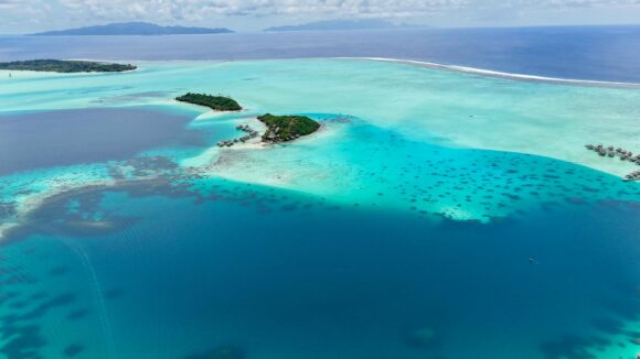 Vista aérea de las aguas turquesas y las islas frondosas de Bora Bora, Polinesia Francesa