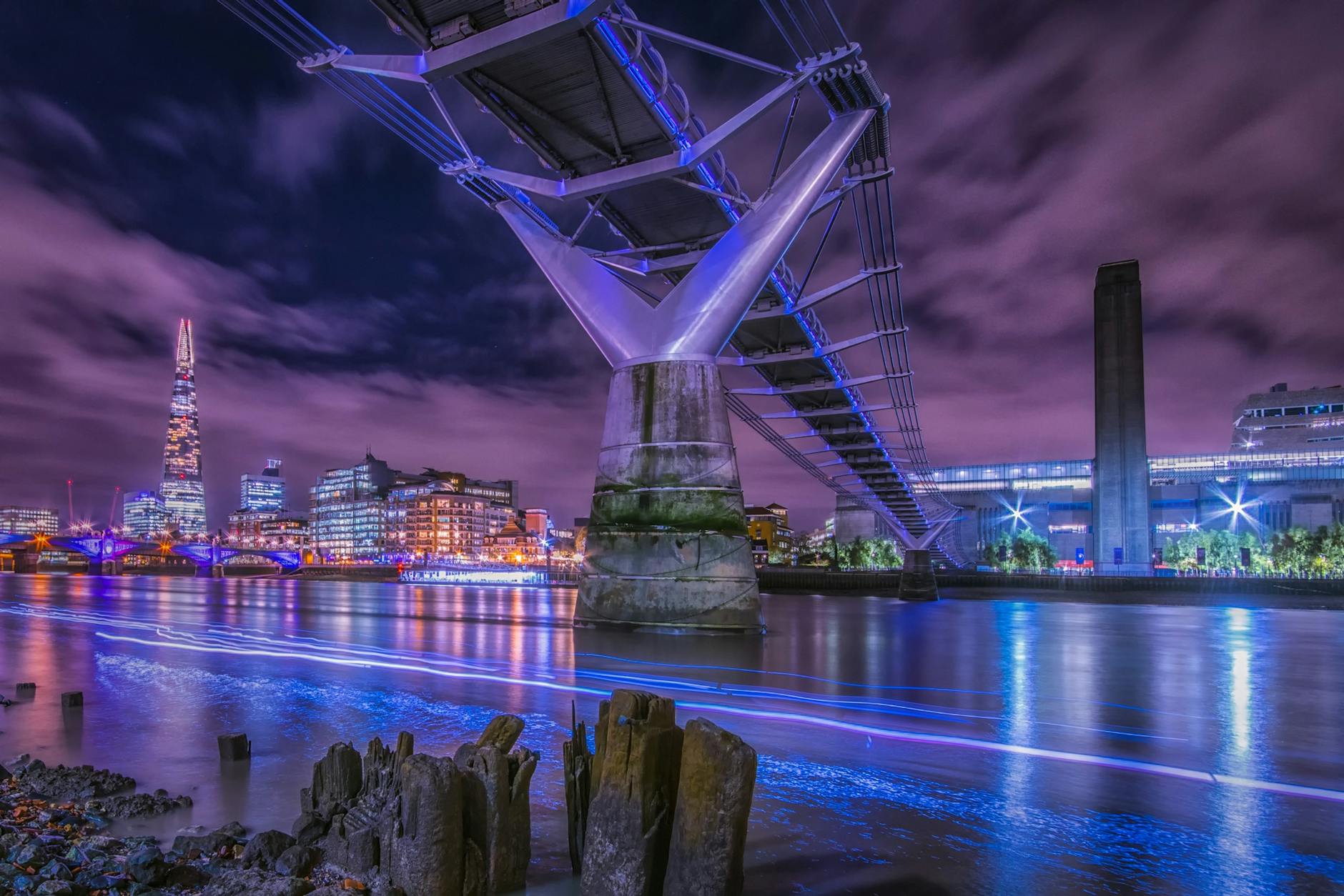 Paisaje urbano de Londres iluminado de noche con puentes y rascacielos