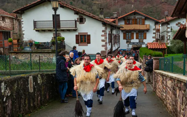 Desfile de hombres con trajes tradicionales en un carnaval español
