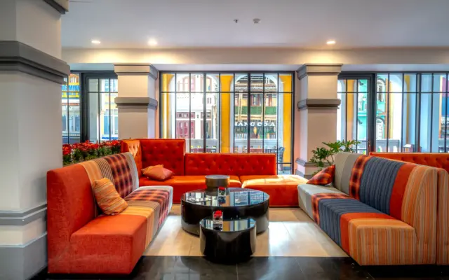 Salón de hotel boutique con asientos de colores y decoración moderna
