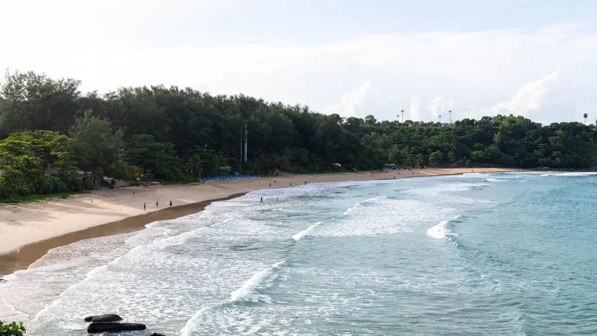 Playa de Phuket, Tailandia, con vegetación exuberante y oleaje suave